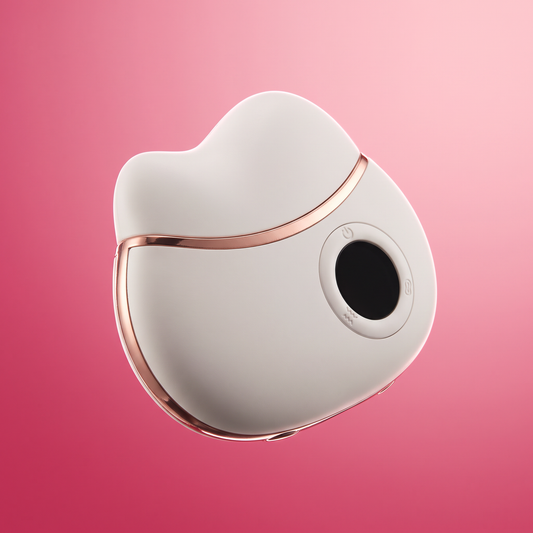 The Ivory Pro Gua Sha, angled studio shot on pink gradient