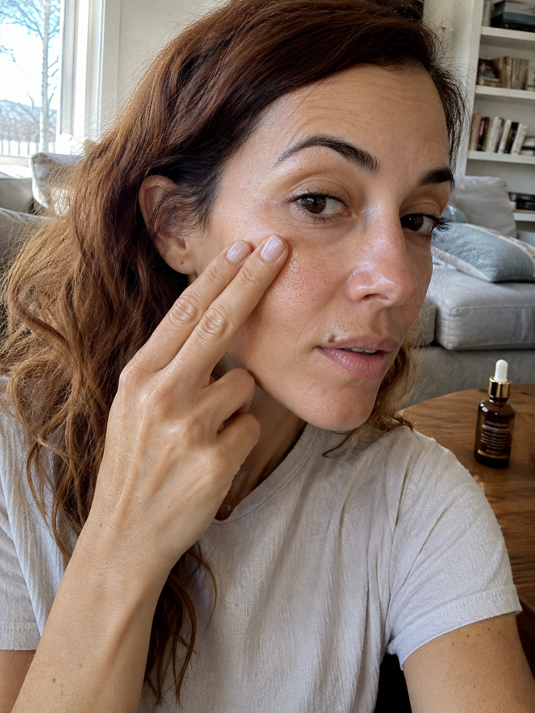 Model applying Luster Bakuchiol Face Oil with syringe applicator
